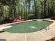 Backyard pool with surrounding concrete decking, diving board and pool ladder at 275 Summertown Dr, Stockbridge, GA 30281