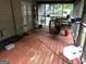 Enclosed porch featuring wood flooring, seating area, and open view of wooded area at 275 Summertown Dr, Stockbridge, GA 30281