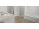 Bright bathroom with a double vanity, a glass-enclosed shower, and a soaking tub at 334 Sound Cir # 120, Stockbridge, GA 30281