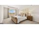 A luxurious bedroom featuring tray ceilings, large windows, and a tufted headboard at 334 Sound Cir # 120, Stockbridge, GA 30281