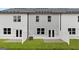 Townhouse exteriors featuring private patios, well-maintained lawns, and neutral color schemes at 334 Sound Cir # 120, Stockbridge, GA 30281