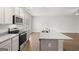 Kitchen area featuring a large island with sink, stainless steel appliances, and granite countertops at 334 Sound Cir # 120, Stockbridge, GA 30281