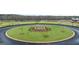 Circular street median with manicured landscaping and young trees adds visual appeal at 334 Sound Cir # 120, Stockbridge, GA 30281