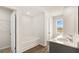 Bright bathroom featuring double sink vanity, soaking tub and vinyl plank flooring at 334 Sound Cir, Stockbridge, GA 30281