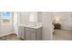 Bathroom with double sink vanity, modern fixtures, and view to the bedroom at 334 Sound Cir, Stockbridge, GA 30281