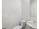 Clean half-bath featuring a sleek toilet and sink with modern fixtures at 334 Sound Cir, Stockbridge, GA 30281