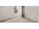Neutral-toned bedroom with plush neutral carpet, window, and door to closet at 334 Sound Cir, Stockbridge, GA 30281