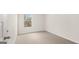 A cozy bedroom with a window view and plush neutral carpet flooring at 334 Sound Cir, Stockbridge, GA 30281