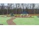 Community area showcasing a playground, gazebo and path winding through landscaped grounds surrounded by mature trees at 334 Sound Cir, Stockbridge, GA 30281