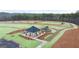 Aerial view of a community area features a playground, gazebo, and walkways winding through beautifully landscaped grounds at 334 Sound Cir, Stockbridge, GA 30281