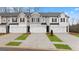 Row of new townhomes each featuring a two-car garage and coordinated landscaping, with an attractive modern exterior at 334 Sound Cir, Stockbridge, GA 30281