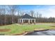 Community gazebo offers a charming outdoor space with stone columns and a pyramidal roof, surrounded by lush green lawn at 334 Sound Cir, Stockbridge, GA 30281