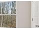 Bedroom with an exterior view through window of a wooded scenery at 334 Sound Cir, Stockbridge, GA 30281