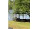 Charming dock with a covered picnic table overlooking the serene lake, perfect for relaxing and enjoying the waterfront at 117 Rendition Dr, Mcdonough, GA 30253