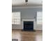 Comfortable living room featuring a black marble fireplace and two windows at 117 Rendition Dr, Mcdonough, GA 30253