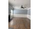 Spacious living room with fireplace, ceiling fan, and hardwood floors at 117 Rendition Dr, Mcdonough, GA 30253
