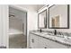 Modern bathroom vanity with granite countertops, double sinks, black hardware, and framed mirrors at 1962 Compton Dr, Atlanta, GA 30315