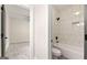 Modern bathroom with gray tile, a bathtub, shower, and stylish dark hardware at 1962 Compton Dr, Atlanta, GA 30315