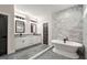Elegant bathroom featuring a soaking tub, dual vanities with granite counters, and marble tiled shower at 1962 Compton Dr, Atlanta, GA 30315