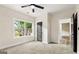 Bright bedroom with a ceiling fan, neutral walls, carpet, and large windows offering natural light at 1962 Compton Dr, Atlanta, GA 30315