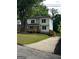 Two-story home with a cozy front porch, manicured lawn, and convenient driveway at 1962 Compton Dr, Atlanta, GA 30315