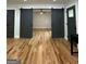 Hallway with hardwood floors, modern barn doors, and access to multiple rooms at 1962 Compton Dr, Atlanta, GA 30315