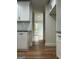 Hallway view with white cabinets, hardwood floors, and recessed lighting throughout at 1962 Compton Dr, Atlanta, GA 30315