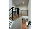 Second story hallway overlooking kitchen with modern iron railings and hardwood floors at 1962 Compton Dr, Atlanta, GA 30315