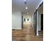 Bright hallway with hardwood floors and modern barn doors, leading to open rooms at 1962 Compton Dr, Atlanta, GA 30315