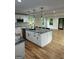 Bright kitchen featuring a large island with granite countertops, modern appliances, and beautiful hardwood floors at 1962 Compton Dr, Atlanta, GA 30315