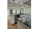 Modern kitchen island with granite countertops, pendant lighting, and stainless steel appliances at 1962 Compton Dr, Atlanta, GA 30315