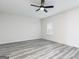 Minimalist bedroom design, showcasing modern vinyl flooring, neutral walls, bright natural light, and a ceiling fan at 3353 Arabian Farm Ln, Dacula, GA 30019