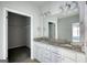 Bathroom features a double vanity with granite countertop and walk-in closet at 695 Park Place Way, Social Circle, GA 30025