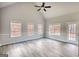 Bedroom with vaulted ceiling and ceiling fan has a back door that leads to outside at 695 Park Place Way, Social Circle, GA 30025