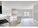 Bright open-plan kitchen with stainless appliances and island at 695 Park Place Way, Social Circle, GA 30025
