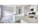 Modern kitchen features granite countertops, a kitchen island, stainless steel appliances and white cabinetry at 695 Park Place Way, Social Circle, GA 30025