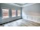 Bright living room featuring large windows with custom trim and moldings, and light wood flooring at 695 Park Place Way, Social Circle, GA 30025