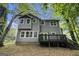 View of backyard featuring a two-story house with a wooden deck and steps to the yard at 1397 Thomas Rd, Decatur, GA 30030