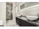 A modern bathroom with double sinks, a vanity, and a separate glass-enclosed shower at 1397 Thomas Rd, Decatur, GA 30030
