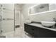 Elegant bathroom featuring dual sinks, a marble countertop, and a spacious glass-enclosed shower at 1397 Thomas Rd, Decatur, GA 30030
