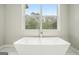 Freestanding bathtub boasts natural light and a view of the outdoors at 1397 Thomas Rd, Decatur, GA 30030