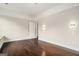 Bright bedroom with hardwood floors, natural light, and modern wall sconces at 1397 Thomas Rd, Decatur, GA 30030
