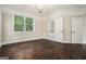 A bedroom with hardwood floors, neutral walls, and a window with a view of the surrounding greenery at 1397 Thomas Rd, Decatur, GA 30030
