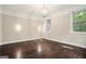Bright bedroom featuring hardwood floors, neutral walls, and a stylish chandelier at 1397 Thomas Rd, Decatur, GA 30030