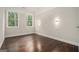 Bright bedroom featuring hardwood floors, natural light, and modern wall sconces at 1397 Thomas Rd, Decatur, GA 30030