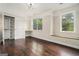 Bedroom with hardwood floors, natural light, built in desk, and organized closet at 1397 Thomas Rd, Decatur, GA 30030