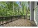 View of the wooden deck overlooking lush greenery and trees in the backyard at 1397 Thomas Rd, Decatur, GA 30030