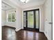 Elegant entryway with a dark wood floor, decorative front door with sidelights, and trim work at 1397 Thomas Rd, Decatur, GA 30030