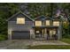 Charming two-story home features a covered porch, stone accents, and an attached two-car garage at 1397 Thomas Rd, Decatur, GA 30030