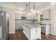 Modern kitchen boasts gray cabinets, stainless steel appliances, a white island, and stylish pendant lighting at 1397 Thomas Rd, Decatur, GA 30030